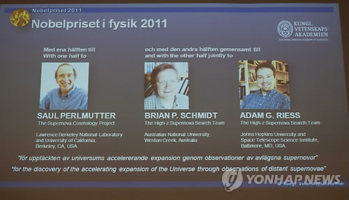 epa02950067 A screen showing the pictures of the three scientists who won the 2011 Nobel Prize in Physics for a study of exploding stars that discovered that the expansion of the universe is accelerating, is seen during the Nobel prize committee presser i